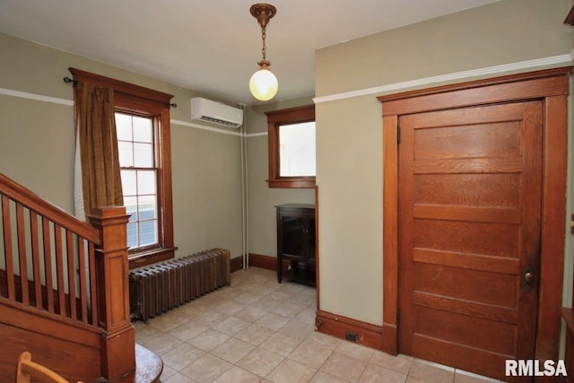102 2nd St, Camp Grove, IL 61424 - entrance foyer featuring radiator, a wall unit AC, baseboards, light tile patterned flooring, and stairs