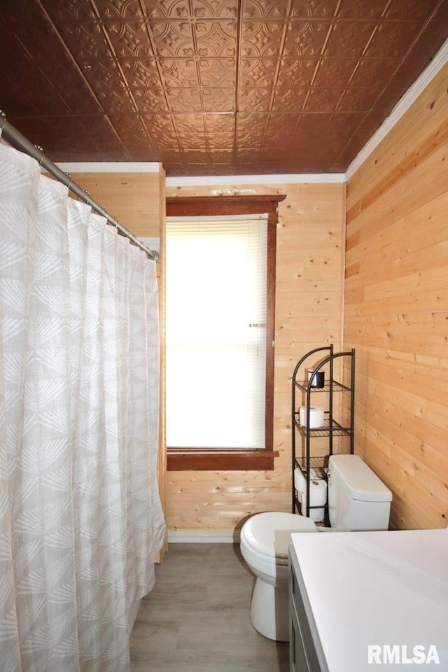 102 2nd St, Camp Grove, IL 61424 - bathroom with wood walls, toilet, an ornate ceiling, baseboards, and wood finished floors