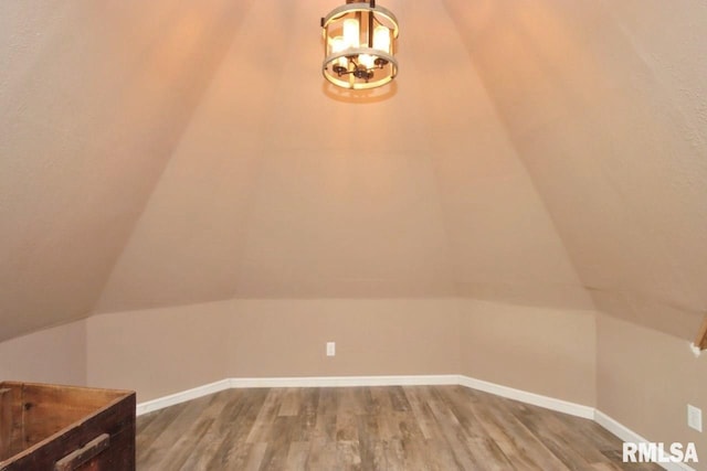 102 2nd St, Camp Grove, IL 61424 - bonus room featuring wood finished floors, a chandelier, vaulted ceiling, and baseboards