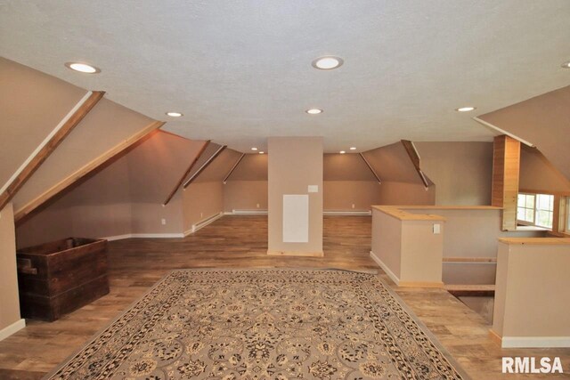 102 2nd St, Camp Grove, IL 61424 - additional living space with wood finished floors, baseboards, recessed lighting, and vaulted ceiling