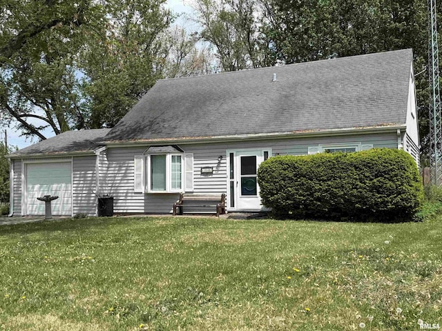 cape cod-style house featuring an attached garage and a front yard