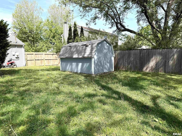 view of yard with a storage shed and an outbuilding