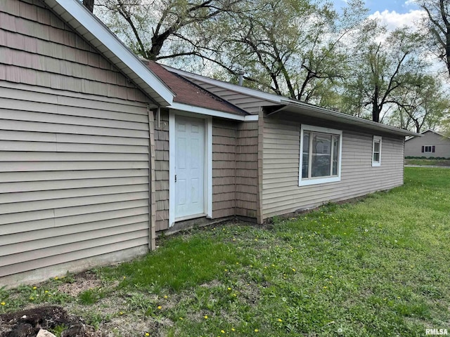 doorway to property with a yard