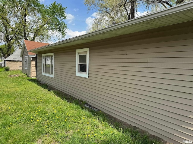 view of side of home featuring a yard
