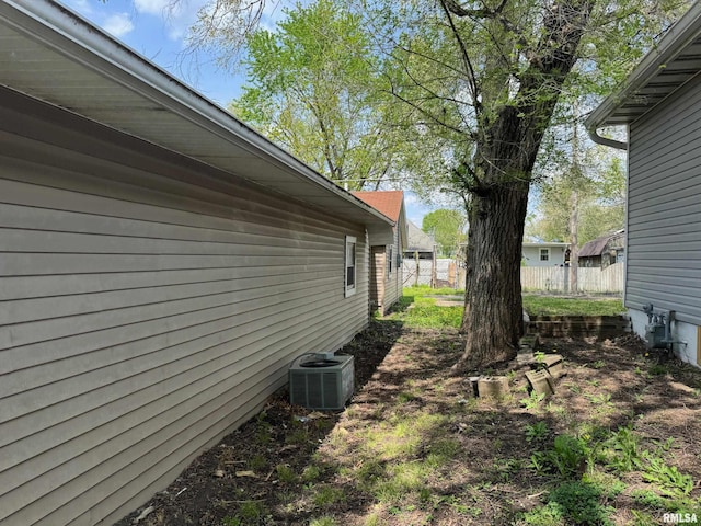 view of property exterior featuring cooling unit and fence