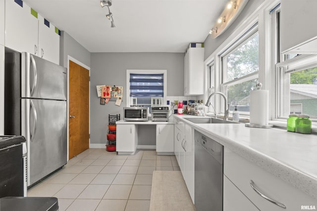 2220 W Ayres Ave, West Peoria, IL 61604 - kitchen featuring stainless steel appliances, a sink, light countertops, and white cabinets
