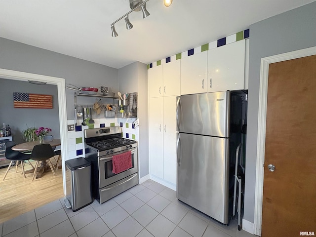 2220 W Ayres Ave, West Peoria, IL 61604 - kitchen featuring stainless steel appliances, light tile patterned floors, and white cabinets