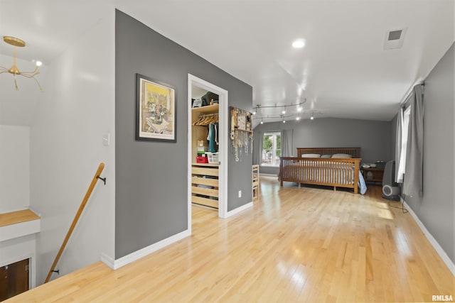 2220 W Ayres Ave, West Peoria, IL 61604 - bedroom with wood finished floors, a spacious closet, a chandelier, baseboards, and a closet