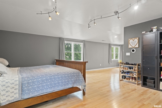 2220 W Ayres Ave, West Peoria, IL 61604 - bedroom featuring track lighting, light wood-style flooring, and baseboards