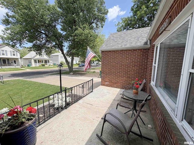 2220 W Ayres Ave, West Peoria, IL 61604 - view of patio / terrace featuring a porch and a residential view