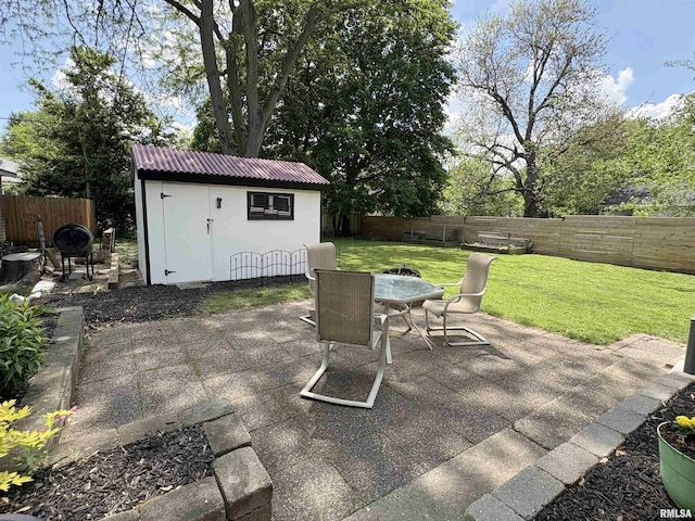 2220 W Ayres Ave, West Peoria, IL 61604 - view of patio featuring outdoor dining space, a storage unit, and an outdoor structure