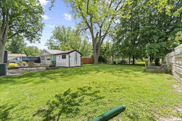 2220 W Ayres Ave, West Peoria, IL 61604 - view of yard with an outbuilding, a storage shed, a patio area, and cooling unit