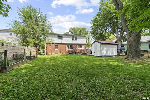 2220 W Ayres Ave, West Peoria, IL 61604 - rear view of house with a vegetable garden, a shed, an outbuilding, and brick siding