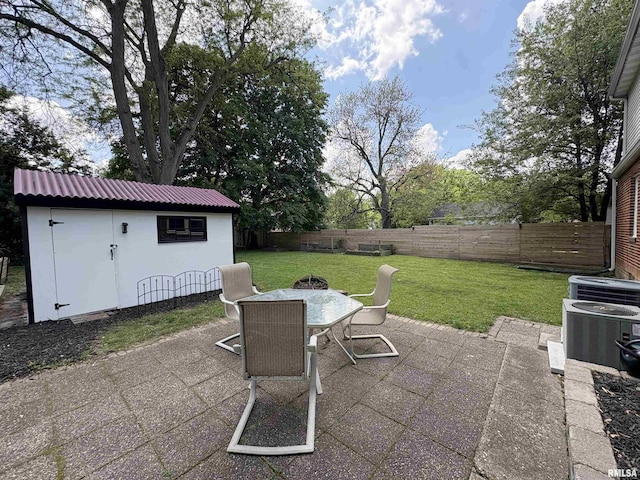 2220 W Ayres Ave, West Peoria, IL 61604 - view of patio featuring outdoor dining space, an outbuilding, and cooling unit