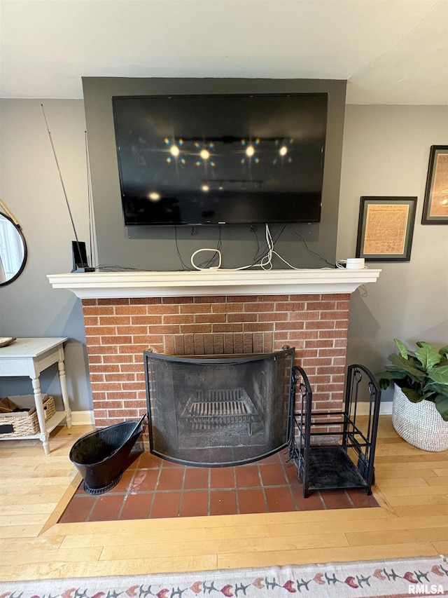 2220 W Ayres Ave, West Peoria, IL 61604 - detailed view of a fireplace, wood finished floors, and baseboards