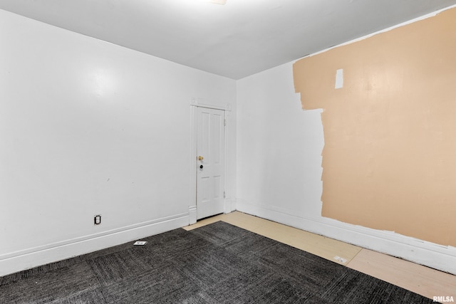 spare room with baseboards