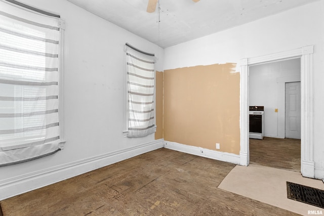 spare room with wood finished floors and ceiling fan