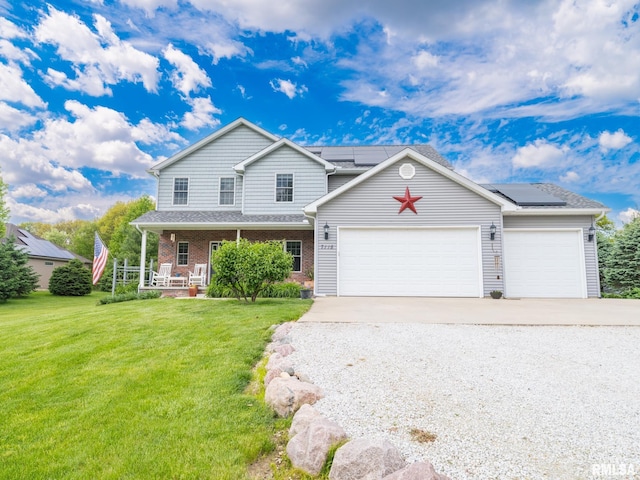 traditional-style home featuring covered porch, concrete driveway, a front lawn, and solar panels