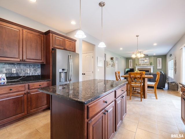 kitchen featuring stainless steel fridge, open floor plan, recessed lighting, hanging light fixtures, and backsplash