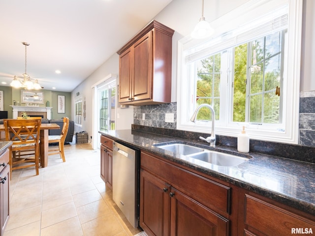 kitchen featuring stainless steel dishwasher, a sink, healthy amount of natural light, light tile patterned flooring, and recessed lighting
