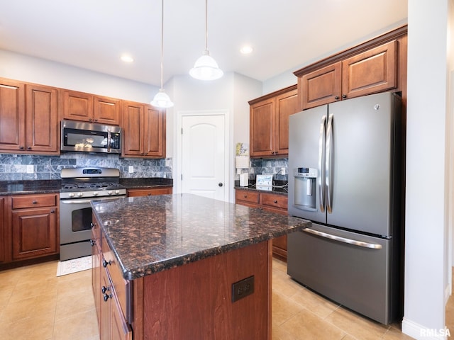 kitchen featuring stainless steel appliances, decorative backsplash, light tile patterned floors, a center island, and hanging light fixtures