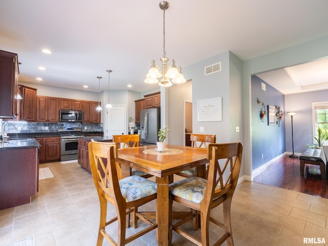 dining area with a chandelier, light tile patterned floors, recessed lighting, and baseboards