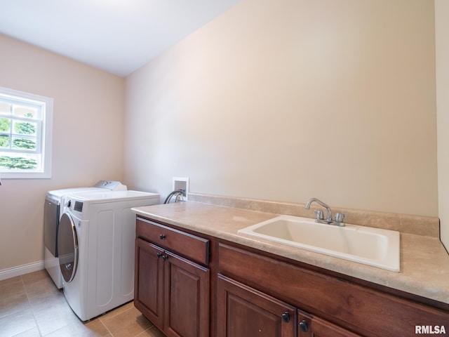 laundry area with washer and dryer, cabinet space, light tile patterned floors, and baseboards