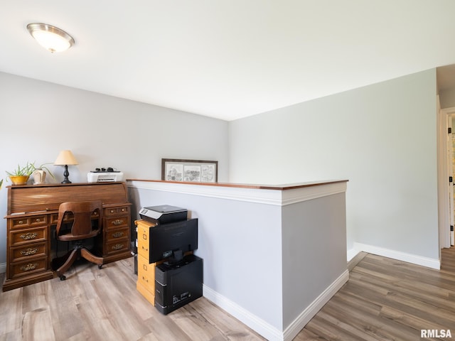 office space with light wood-style flooring and baseboards