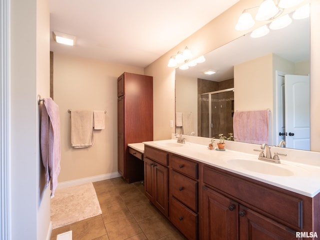 bathroom featuring a stall shower, double vanity, tile patterned floors, and baseboards