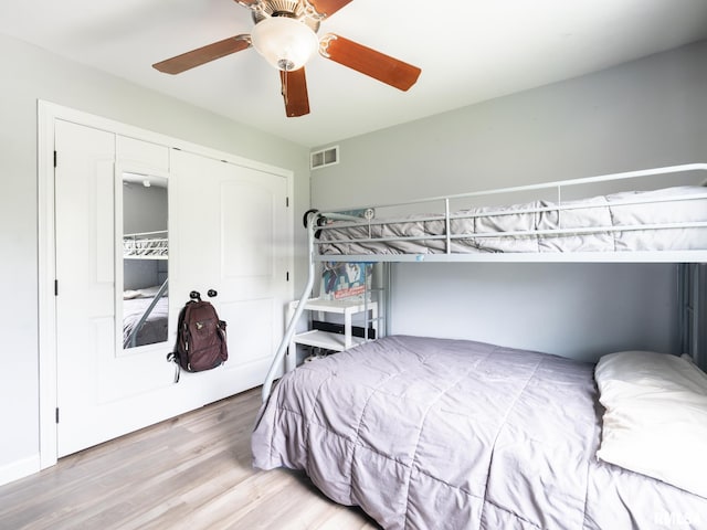 bedroom with wood finished floors, a closet, and a ceiling fan