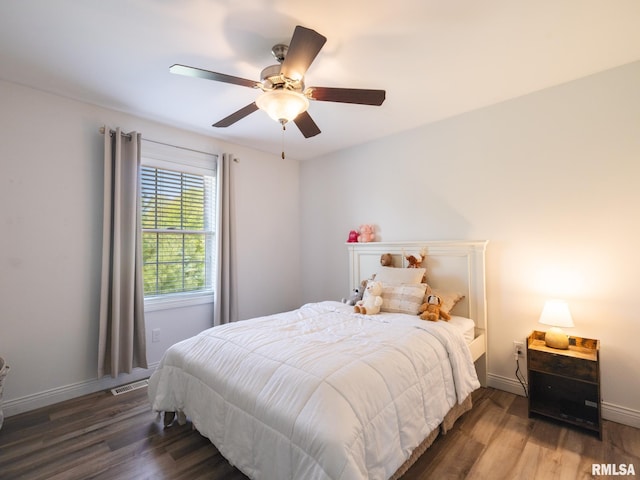 bedroom with wood finished floors, ceiling fan, and baseboards