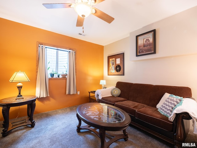 living area featuring carpet flooring and a ceiling fan