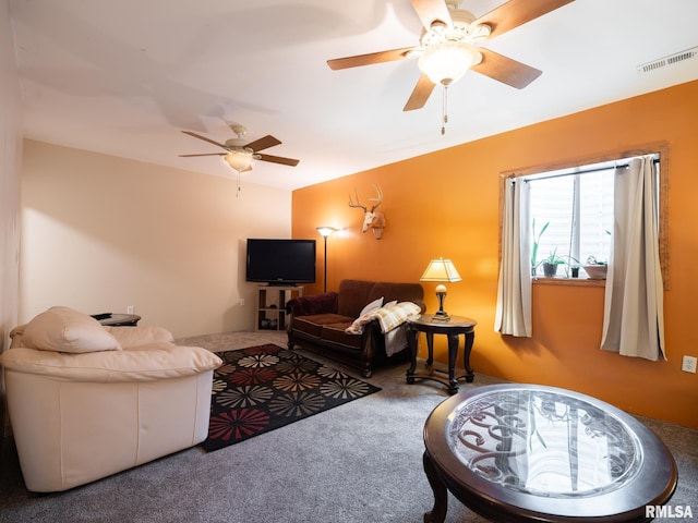 carpeted living room featuring a ceiling fan