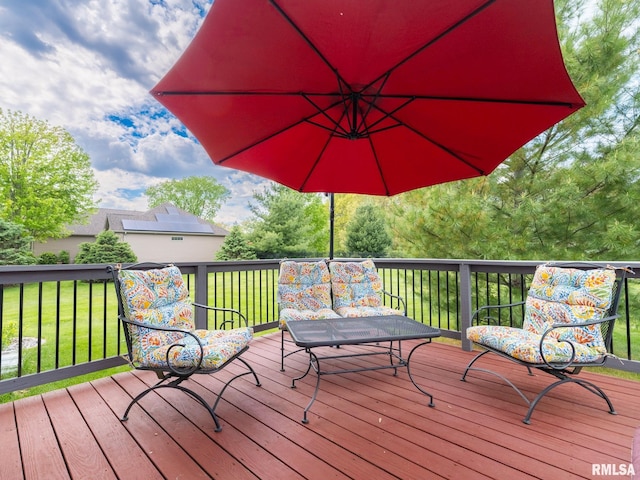 wooden deck featuring a lawn