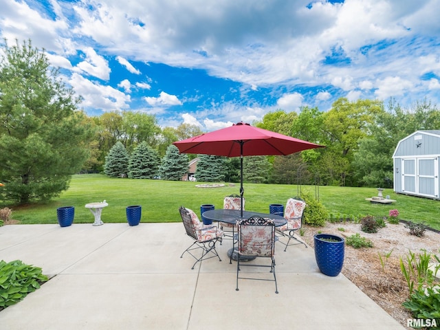 view of patio / terrace with a storage shed, an outdoor structure, and outdoor dining space