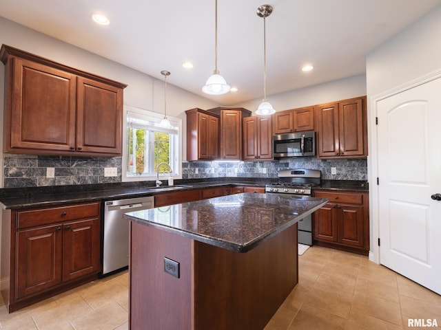kitchen with stainless steel appliances, a sink, light tile patterned flooring, backsplash, and hanging light fixtures