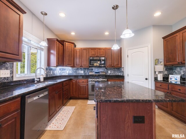 kitchen with appliances with stainless steel finishes, a sink, tasteful backsplash, light tile patterned floors, and recessed lighting