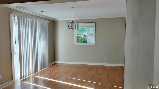 927 W Oakview Dr, Peoria, IL 61615 - spare room featuring wood finished floors, a chandelier, ornamental molding, and baseboards
