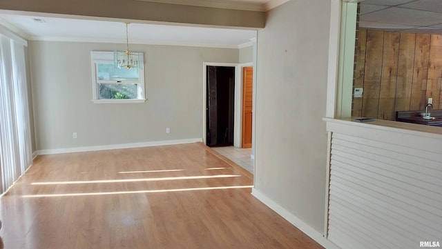 927 W Oakview Dr, Peoria, IL 61615 - unfurnished dining area with ornamental molding, baseboards, a chandelier, and wood finished floors