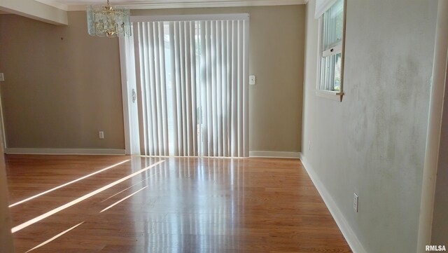 927 W Oakview Dr, Peoria, IL 61615 - unfurnished room with a chandelier, baseboards, wood finished floors, and ornamental molding