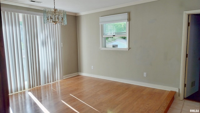 927 W Oakview Dr, Peoria, IL 61615 - spare room with ornamental molding, a chandelier, baseboards, and wood finished floors