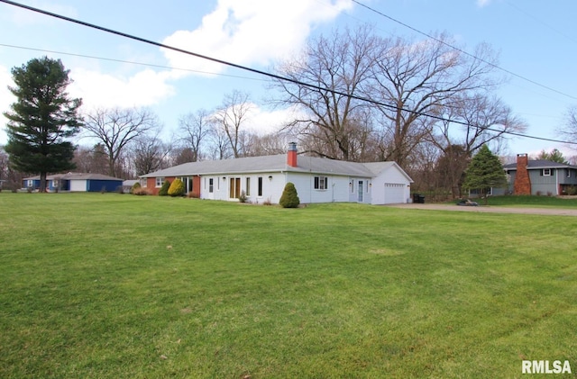 927 W Oakview Dr, Peoria, IL 61615 - ranch-style home with asphalt driveway, a front lawn, a chimney, and an attached garage