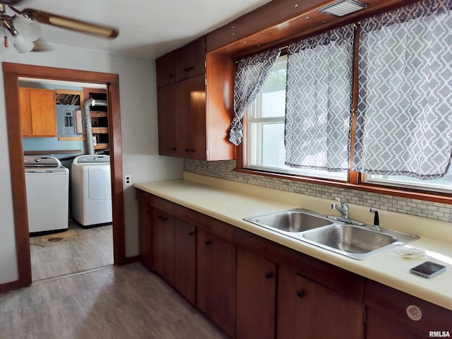 927 W Oakview Dr, Peoria, IL 61615 - kitchen with washing machine and dryer, a sink, light wood-style flooring, and light countertops