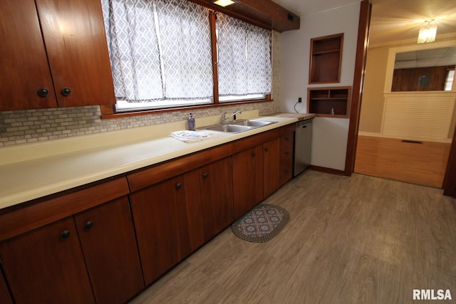 927 W Oakview Dr, Peoria, IL 61615 - kitchen with dishwasher, decorative backsplash, a sink, light countertops, and light wood-style floors