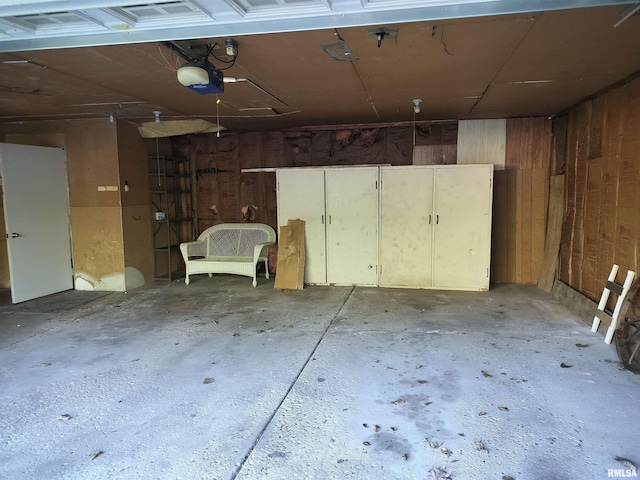 927 W Oakview Dr, Peoria, IL 61615 - garage featuring a garage door opener and wood walls