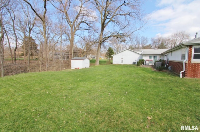 927 W Oakview Dr, Peoria, IL 61615 - view of grassy yard with a shed, an outbuilding, and central AC