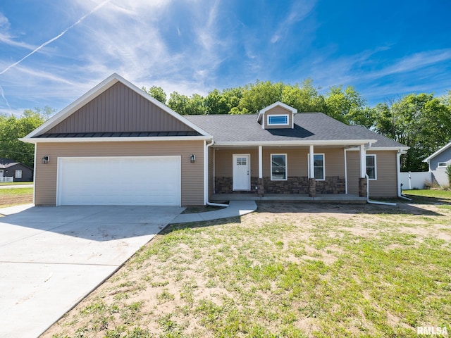view of front of home featuring an attached garage, stone siding, driveway, a porch, and a front lawn