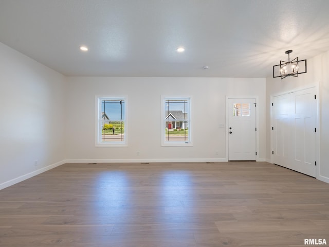 entryway with a chandelier, wood finished floors, baseboards, and recessed lighting