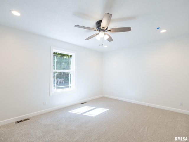 empty room with light colored carpet, recessed lighting, ceiling fan, and baseboards