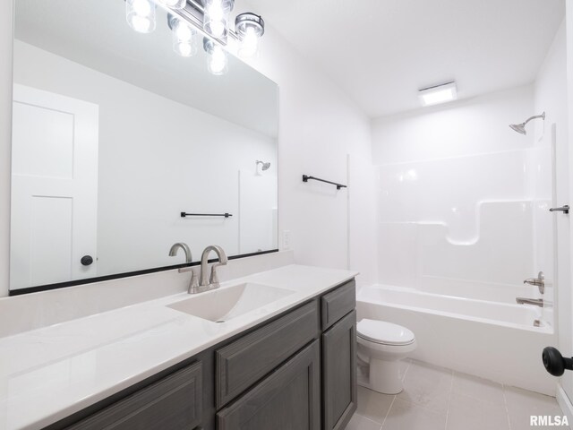 bathroom featuring tile patterned floors, toilet, vanity, and bathtub / shower combination